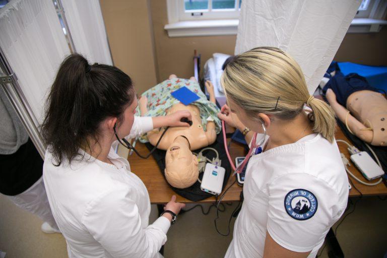 Student nurses work with simulated patient