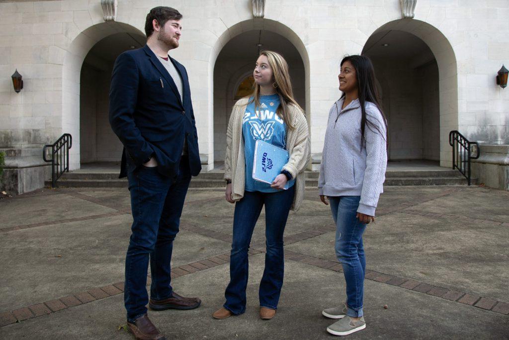 SGA president talks with two students outside
